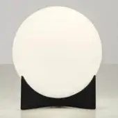 Terzani Oscar table lamp, white opaque glass globe, black arched metal base, minimalist oval shape, studio lighting.