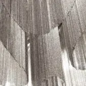 Terzani Stream curtain, nickel-plated metal, cascading layered chains with reflective surface and dense, linear texture.