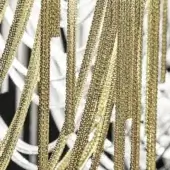 Gold-plated chains in dense arrangement, creating a textured curtain effect against a white background, with varied link styles.