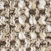 Woven fabric texture, cream and beige tones, irregular looped pattern, natural fiber blend, visible “verzelloni” textile label, detailed close-up.