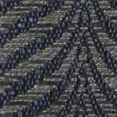 Verzelloni fabric texture, dark indigo ribbed weave, densely knotted surface with heathered tonal variations and consistent diagonal pattern.