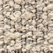Beige looped pile fabric texture with woven text reading “verzelloni,” displaying a nubby, irregular weave and subtle tonal variations.