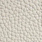 Cream leather texture with repeating polygonal pattern, pebble-grain effect, and subtle tonal variations in diffused studio lighting.