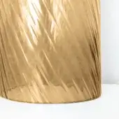 Cylindrical glass lamp with golden fluted texture, modern design, reflective white base, bright illumination, and wave-like surface pattern.