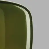 Green glass vessel, Vistosi Jube Vatr style, rounded rectangular shape with thick rim, glossy finish, against gray backdrop.