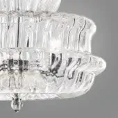 Chandelier with clear ridged glass shades and polished chrome metal framework, featuring curved tiers and a classic ornate design.