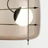Pendant light, amber glass, brass grid – features rounded shade, white globe, black accents, diffused illumination, modern design.