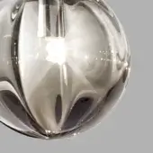 Glass pendant light, smoky gray, spherical shape with radial ridges and polished metal fitting, warm white light visible within.