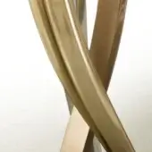 Sculptural metal base, bronze and champagne nickel, with intertwined curving forms and a polished, reflective surface against a neutral gradient.