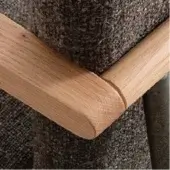 Oak-stained ash armrest with beveled edge, dark brown textured upholstery, and black metal frame detail, displaying visible wood grain.