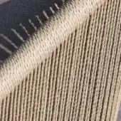 Woven outdoor seating, beige synthetic cord, vertical ribbed texture with gray accent; durable Canapa variation from Varaschin’s Cricket collection.