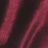 Red-burgundy velour fabric sample, Vismara Brilliant Velour VE17, displays a dense short pile and directional sheen with subtle color variations.