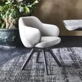 Stylish Cattelan Italia Bombè armchair with light beige soft leather upholstery and graphite lacquered steel base crafted with Canaletto walnut stained legs