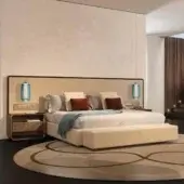 Distinguished Reflex Oh XL bed with woven beige upholstery, quilted headboard and bronze-finished details built with shaped wood and integrated lighting