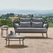 Elegant Varaschin Emma Cross sofa with light gray textile cushions and handcrafted acrylic weaving in powder-coated aluminum