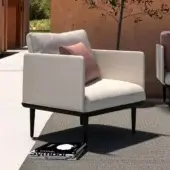 Sophisticated Royal Botania Styletto lounge chair with tapered coated aluminum legs and light beige fabrics with a pink cushion