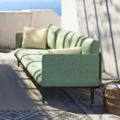 Distinguished Royal Botania Styletto lounge sofa with dark coated aluminum and lush green textured upholstery complemented by beige cushions