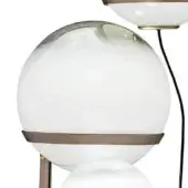 Floor lamp with three white glass shades, brushed bronze metal accents, and a curved slender frame, studio lighting.
