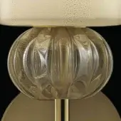 Murano glass table lamp with gold accents, featuring a spherical, ridged glass globe and off-white woven lampshade.
