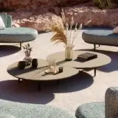 Innovative Royal Botania Organix lounge table with shaped aluminum base and uniquely positioned ceramic tops in light gray matte
