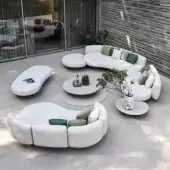 Distinguished Royal Botania Organix lounge sectional with organic shapes upholstered in matte white textile and accented with green beige pillows