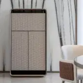 Distinguished Reflex Oh cupboard with rounded wood structure and bronze finish, showcasing light beige leather doors with diamond quilting