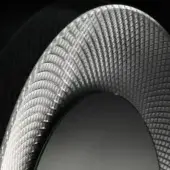 High-performance tire with dark gray sidewall and silver-gray carbon fiber weave, displaying a layered, curved square tile pattern and engraved markings.