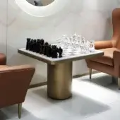 Elegant Reflex Tau Steel Scacchi table with a satin brass cylinder base and marble glass chessboard insert in wood with rounded corners