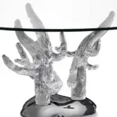 Corallo table, clear glass, circular tabletop supported by two sculptural coral-form bases on a black foundation.