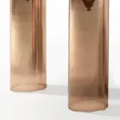 Cylindrical glass vases with bronze gradient finish, featuring vertical ridging and circular indentations, displayed against a white backdrop.