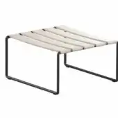 Footrest, beige webbing, rectangular frame; minimalist design with black metal tubing, square base, rounded corners, studio product shot.