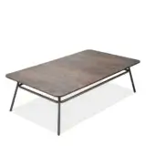 Coffee table, oxidized metal, organic shape; reddish-brown, dark gray mottled tabletop with a thin dark gray metal frame and tapered legs.