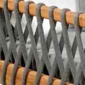 Woven chair back, gray olefin cords, honey-brown wood dowels, diagonal grid pattern, textured surface, durable construction, neutral gray background.