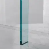 Glass column, clear with blue-green tint, tall rectangular form on light gray floor with minimal dark metal base in neutral minimalist space.