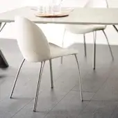Distinguished Cattelan Italia Holly chair with embossed lacquered steel legs and creamy-white upholstery exhibiting a curved silhouette
