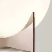 Terzani Luce Pensata table, rose-gold metal, crescent-shaped surface with perpendicular rectangular element, polished reflective finish.