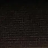 Dark brick wall with irregular pattern, gradient from gray to black, rough texture, horizontal mortar lines, and uniformly shadowy appearance.