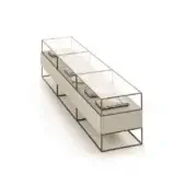 Display case, beige wood and dark gray metal frame, rectangular form with clear glass top displaying books and objects.