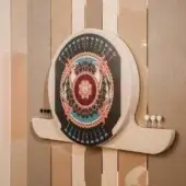 Vismara dartboard cabinet, cream, shield-shaped with gold detailing, peacock feathers, and a circular dartboard design on a dark background.