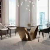 Distinguished Reflex Apeiron table with rectangular glass top and curved iron V-shaped base in bronze or gold toned finish