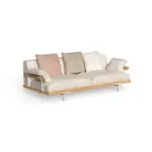 Beige three-seater sofa with rounded arms, light wood accents, and four decorative pillows in rose, olive, and neutral patterns on white metal legs.