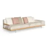 Beige textured sofa with oak frame and silver legs, styled with geometric, pink, green, brown, and quilted pillows.