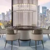 Refined Reflex Big Ben table with cylinder base upholstered in geometrically-patterned quilted leather and dark stone-like tabletop with gold inlay