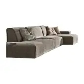 Modular sofa, gray textured fabric, low profile with chaise lounge and patterned, rose accent pillows, studio product shot.