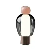 Table lamp, blush pink glass dome, dark smoked glass shade, brushed bronze cylindrical base, stylized flamingo form, studio lighting.
