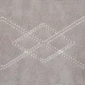 Gray nabuk leather texture with diamond stitching, featuring a pebbled surface and double-stitched rhombus pattern in white.