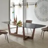 Distinguished Bonaldo Art Wood table with a transparent glass top and sculpted solid American walnut wood trapezoid bases
