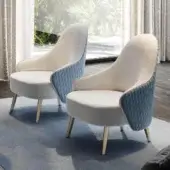 Refined Reflex Ludwig lounge chair with quilted blue textile and light speckled interior upholstery, built with glossy metal legs