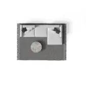 Modular sofa, light gray fabric, three sections with dark patterned pillows on a gray fringed rug with a circular gray side table.