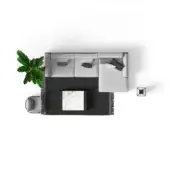 Gray modular sofa with textured upholstery, white marble-top coffee table on black rug, green plant, gray side table, white backdrop.